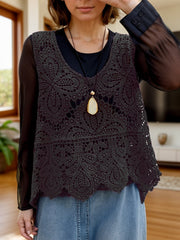 Black lace overlay cropped vest with intricate floral pattern and scalloped hem.