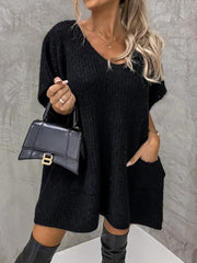 Black knit cocoon dress with V-neck, short sleeves, and patch pockets.