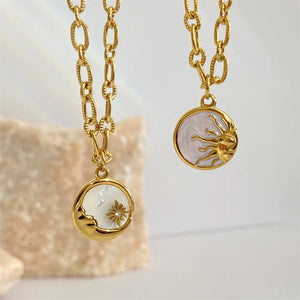Gold chain necklace with celestial moon and sun pendants, one with pearl and star detail