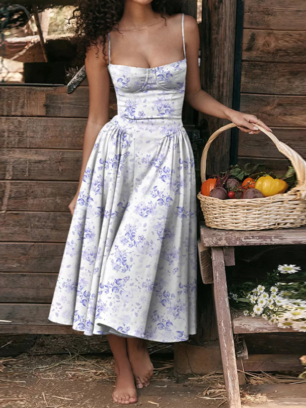 Floral midi dress with sweetheart neckline and spaghetti straps in white with purple floral print.