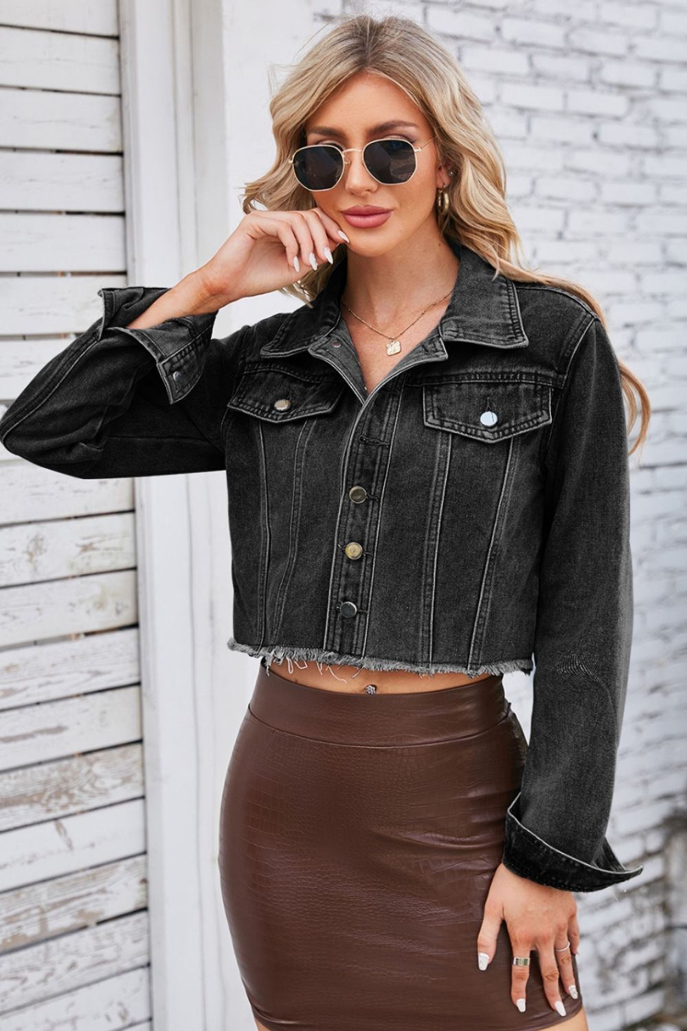 Black washed denim bolero jacket with raw hem and button front.