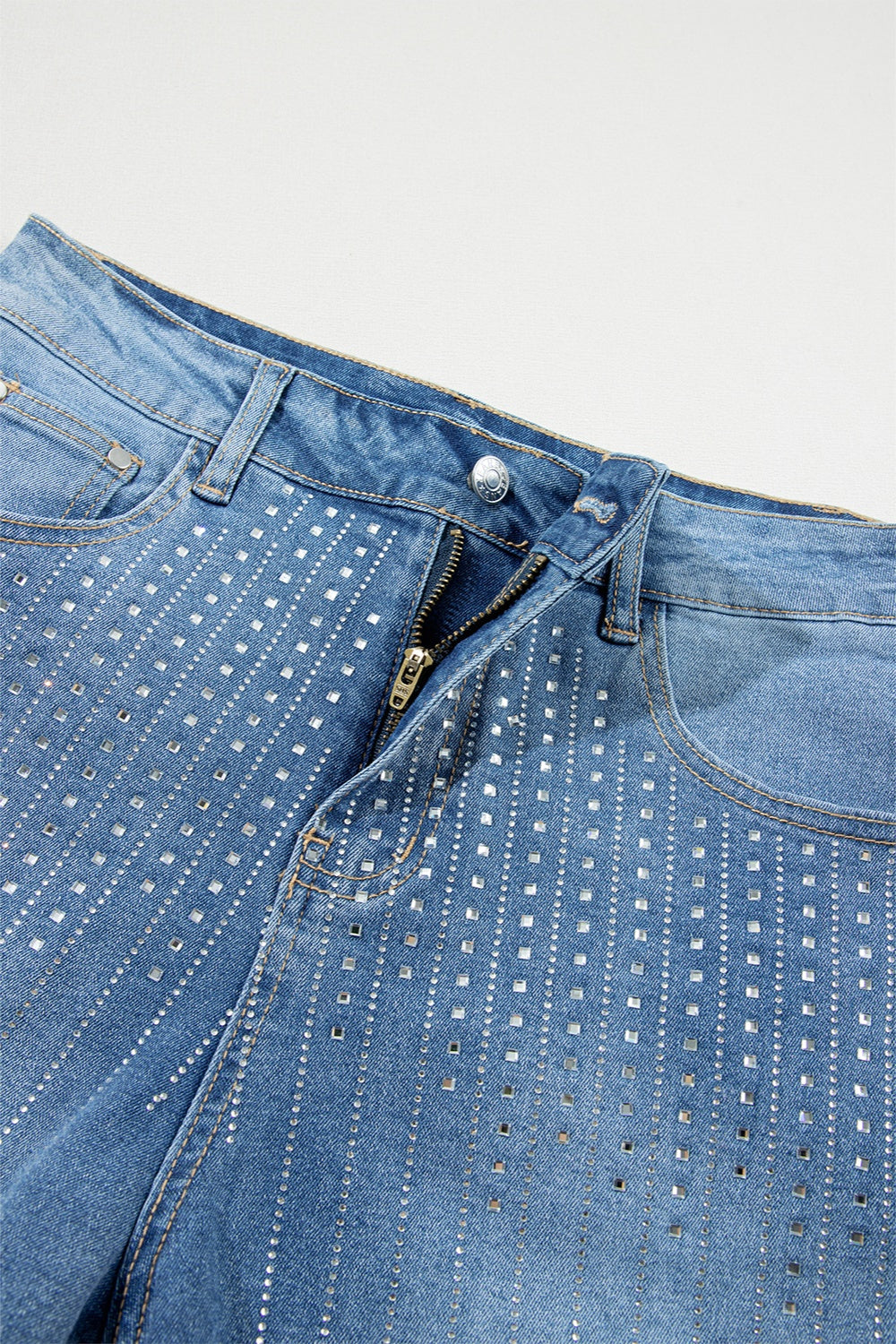 Embellished denim shorts in medium wash with allover rhinestone detail.