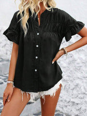 Black button-up blouse with gathered yoke and ruffle sleeves.