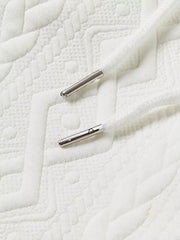 White knit shorts with textured pattern and silver-tipped drawstring.