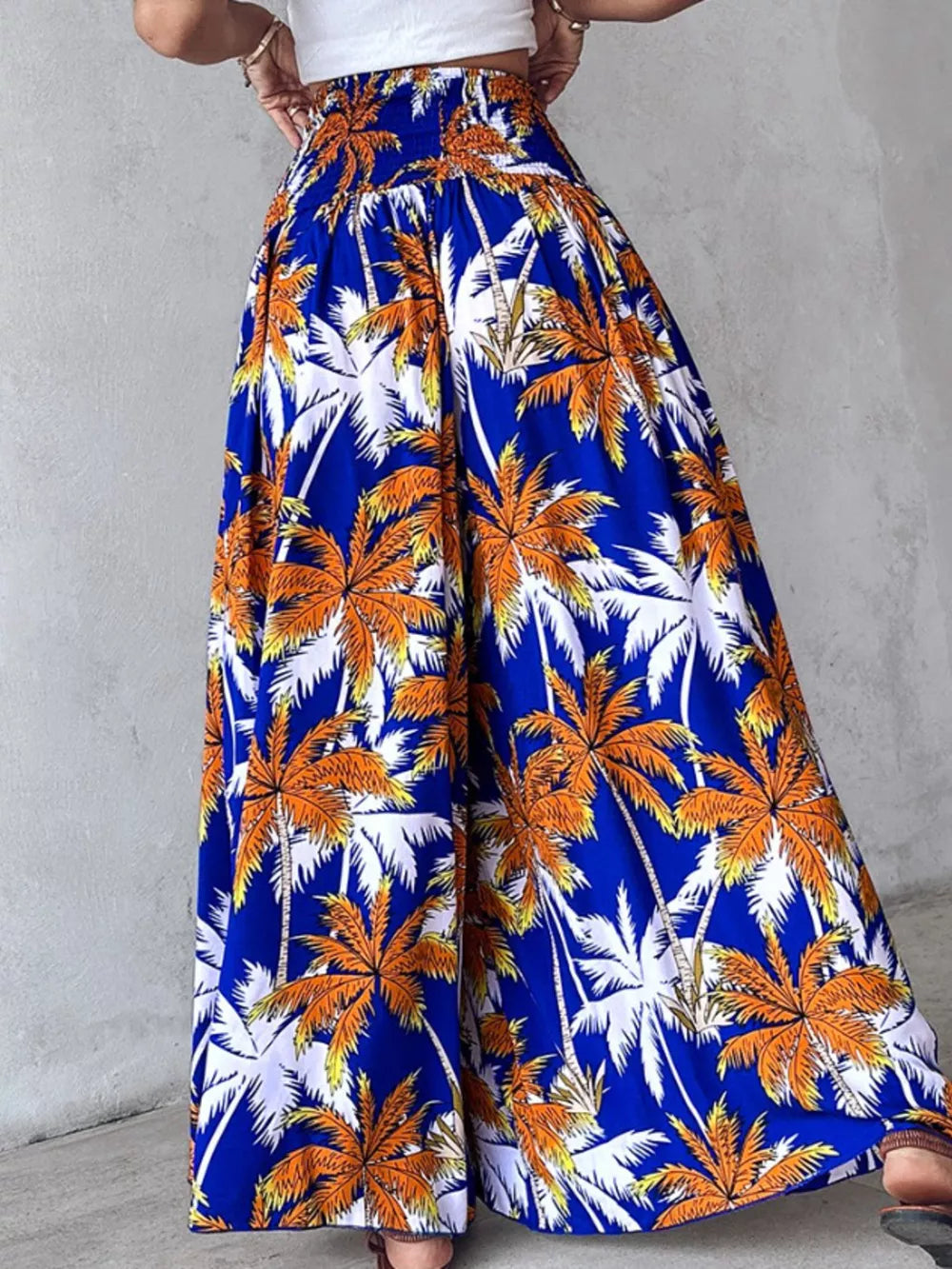 Bohemian print wide-leg pants in Royal Blue with smocked waist and palm tree pattern.