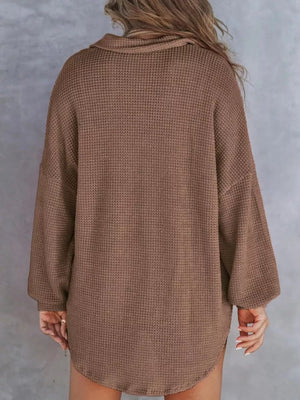 Brown waffle-knit henley tee with a collar and long sleeves.