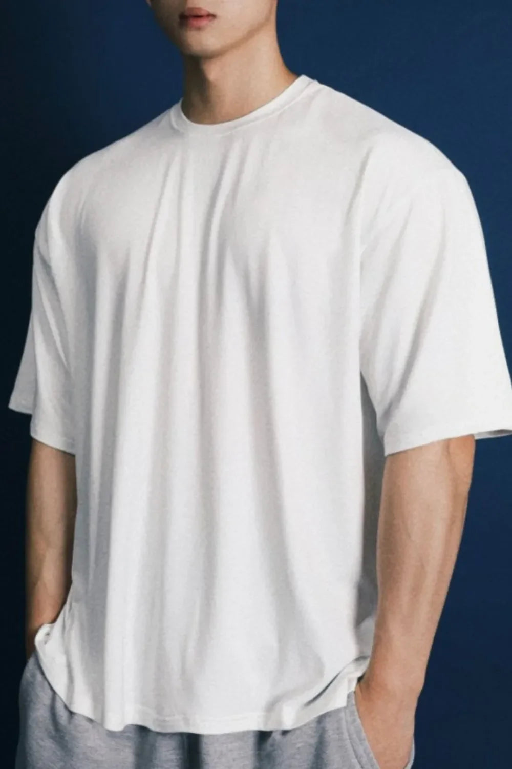 Oversized white crew neck t-shirt with a modern silhouette and short sleeves.