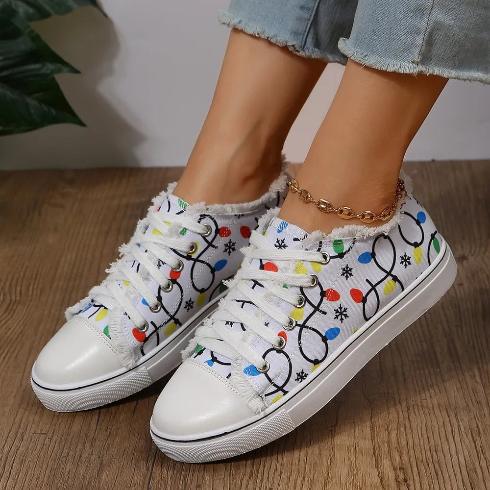 White canvas sneakers with string light pattern and fringe trim.
