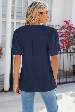 Dark Blue eyelet blouse with V-neck and puff sleeves.