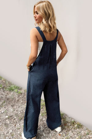 Textured wide-leg pinafore jumpsuit in Peacock Blue with buttoned details.