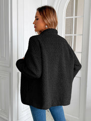 Black teddy fleece jacket with patch pockets, mock neck, and long sleeves.
