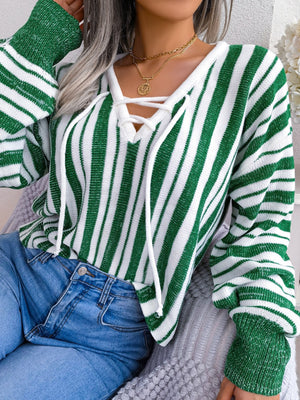 Green and white striped knit cropped pullover sweater with lace-up neckline detail.