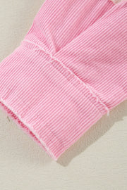 Blush pink corduroy shacket cuff with raw edge detail and visible stitching.