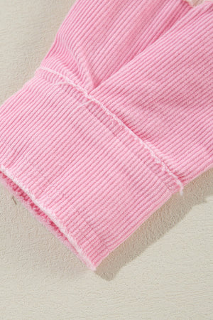 Blush pink corduroy shacket cuff with raw edge detail and visible stitching.