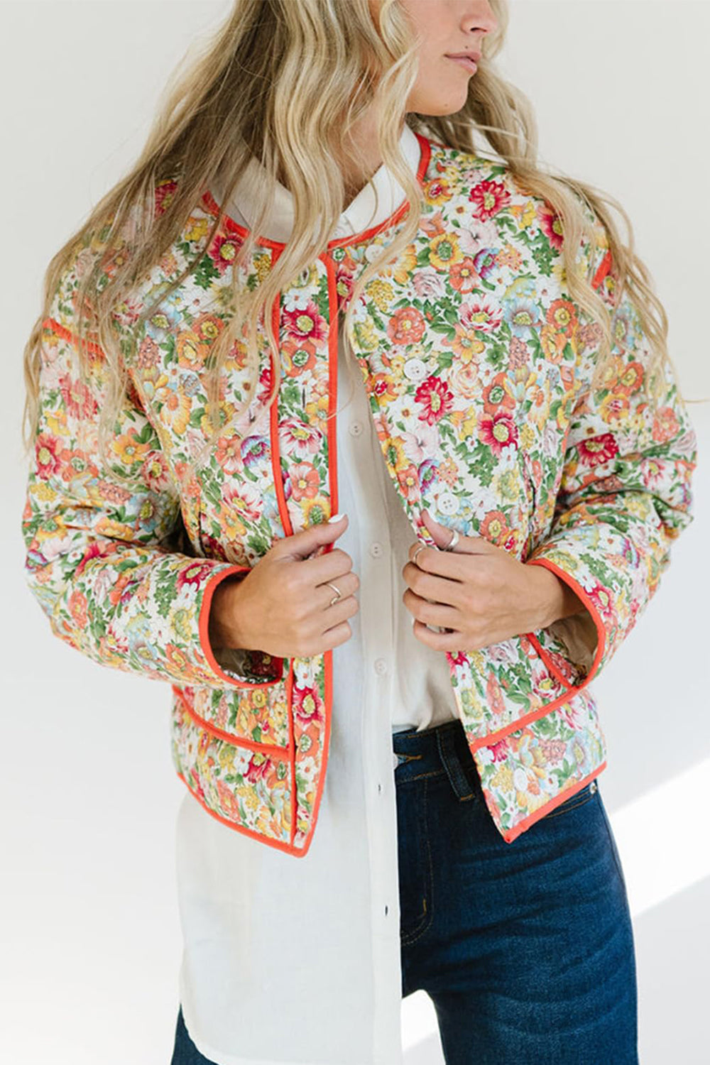 Floral quilted jacket with contrast piping and a stand-up collar.
