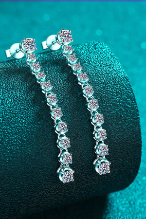 Silver linear drop earrings with cascading moissanite stones.
