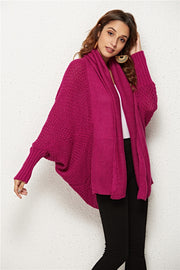 Cocoon knit cardigan in deep purple with shawl collar and batwing sleeves.