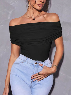 Black off-shoulder ruched t-shirt with short sleeves, styled with light wash jeans.