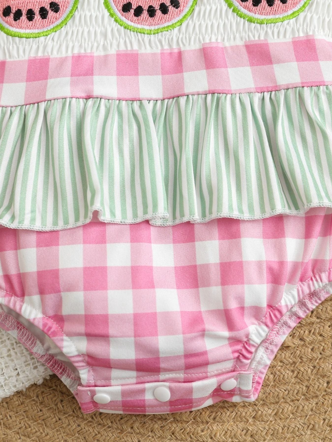 Baby one-piece swimsuit with watermelon embroidery, pink gingham, and green stripe ruffles.