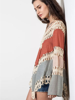 Crochet-trimmed long sleeve cardigan in colorblock with fringe detail.