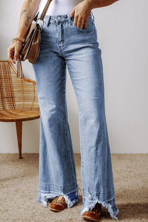 Medium wash denim flare jeans with raw hem detail