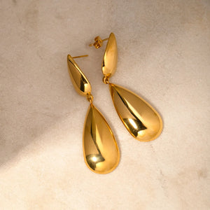 Gold teardrop dangle earrings with a polished finish.