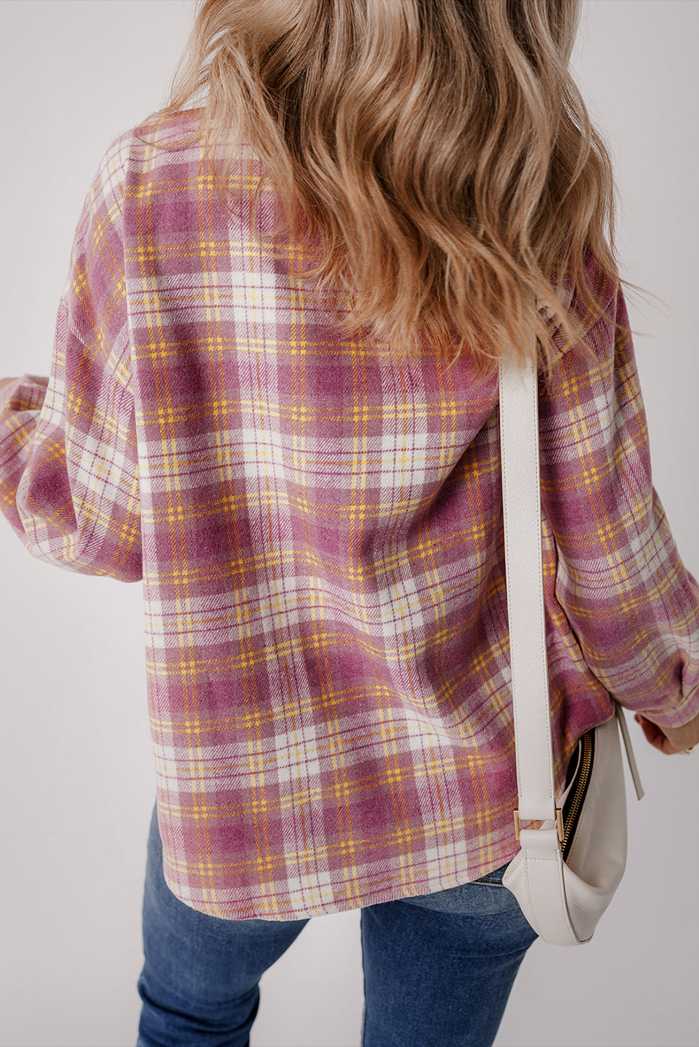 Oversized pink plaid flannel button-down shirt with white and yellow accents.