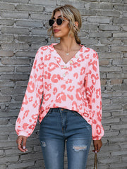 Pink leopard print blouse with blouson sleeves and button detail