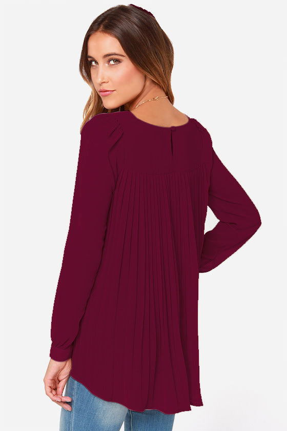 Burgundy long sleeve blouse with pleated back detail and round neckline.