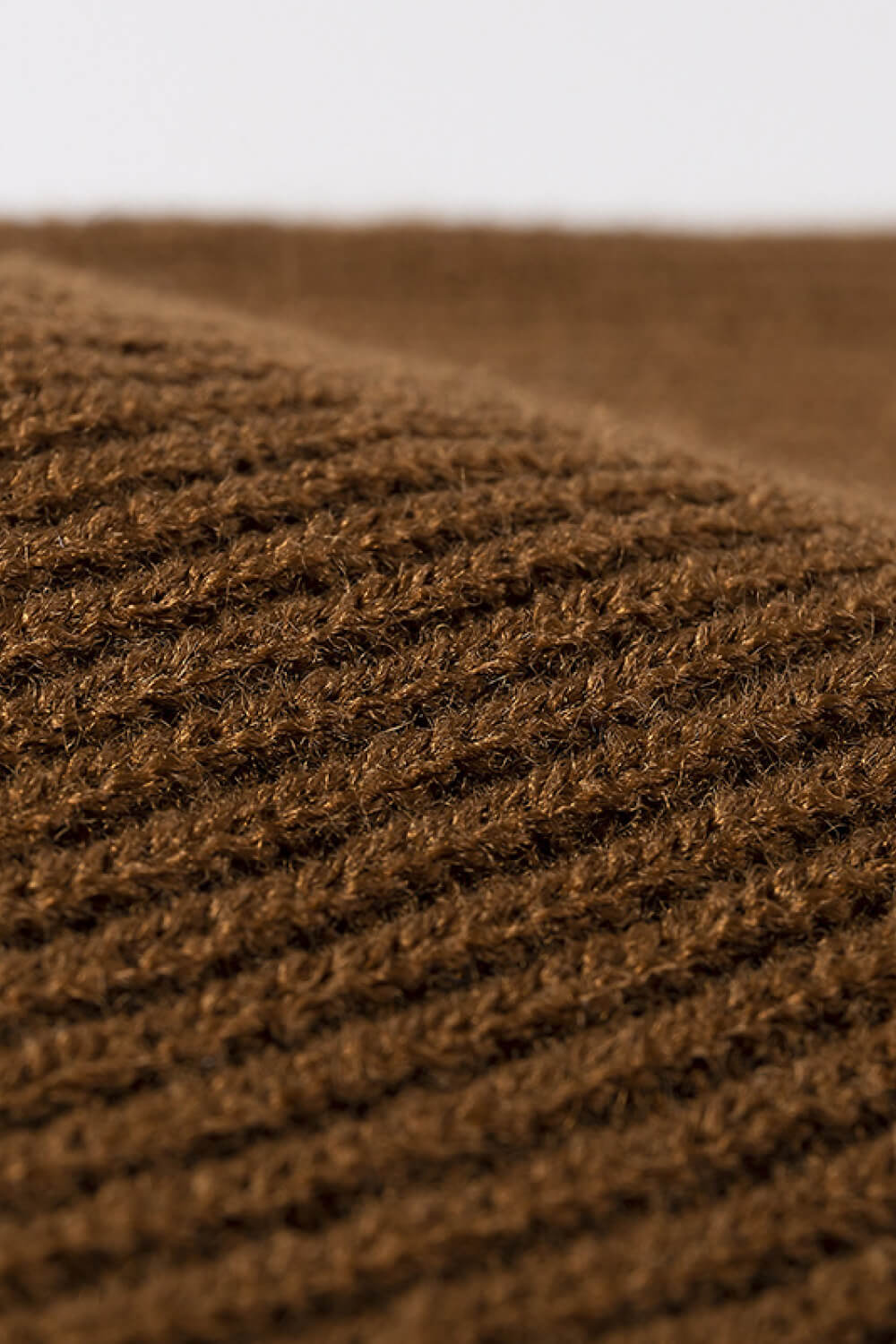 Brown ribbed knit beanie showing acrylic texture detail