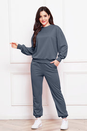 Relaxed fit dark gray loungewear set with crewneck sweatshirt and jogger pants.