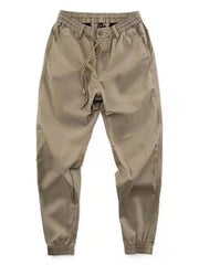 Khaki drawstring joggers with elastic cuffs and relaxed fit.