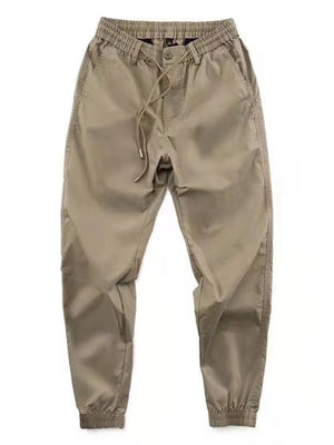 Khaki drawstring joggers with elastic cuffs and relaxed fit.