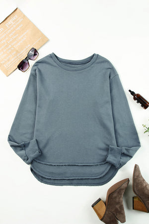 Dull Blue sweatshirt with asymmetric raw hemline and crew neck.