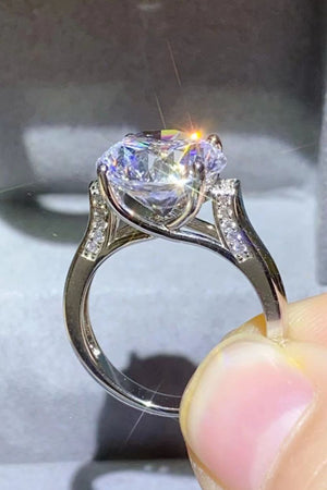 Radiant moissanite solitaire ring with pavé shoulders in silver.