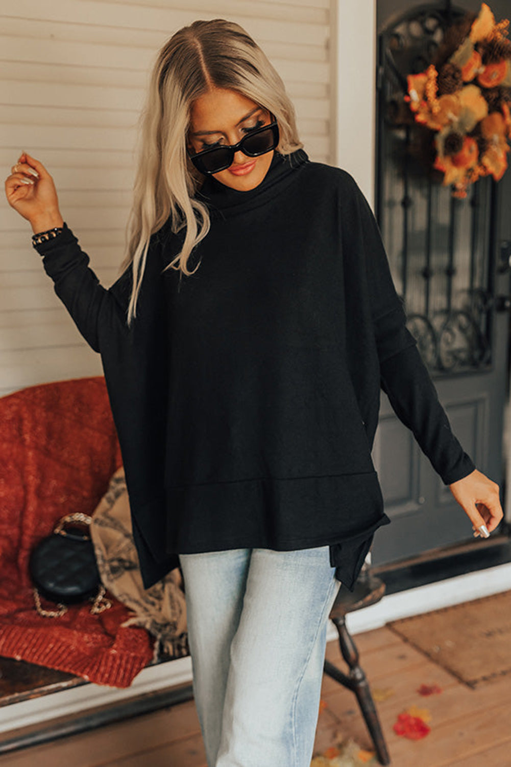 Black cowl neck tunic with drape-front detail and long sleeves.