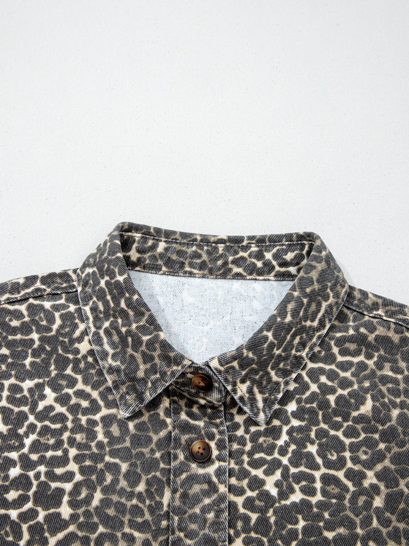 Denim leopard print shirt with button front and collar.