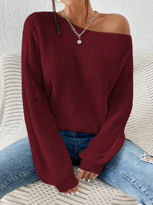 Burgundy ribbed knit off-shoulder top with balloon sleeves, styled with jeans.