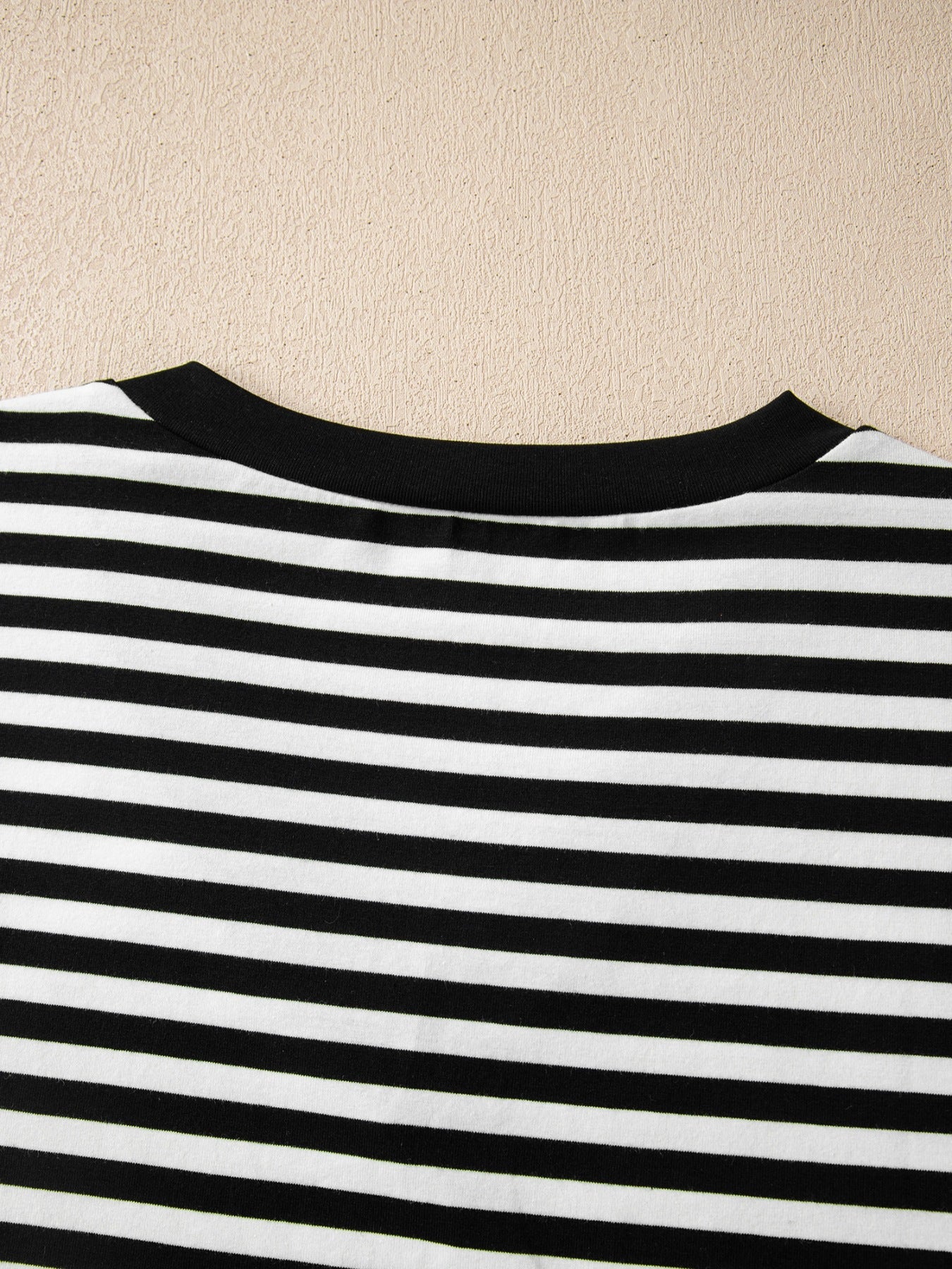 Classic black and white striped cotton V-neck t-shirt with black trim.