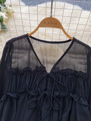 Black chiffon blouse with V-neck, tie front, and ruffled details.
