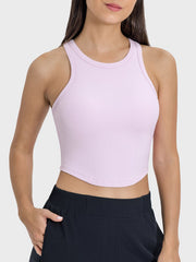 Blush pink ribbed racerback active tank top with round neckline.