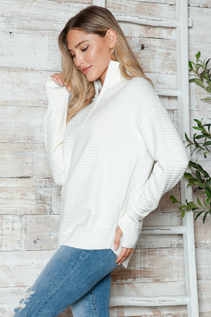 White ribbed knit pullover sweater with funnel neck and quarter zip, long sleeves.