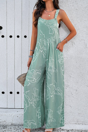 Light green abstract scribble wide leg jumpsuit with pockets and button straps.