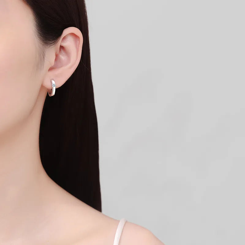 Silver moissanite hoop earrings crafted from 925 sterling silver.