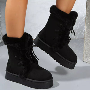 Black suede lace-up platform boots with faux fur trim and lug sole.