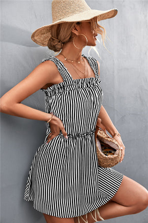 Black and white striped mini dress with ruffle yoke and elastic waist.