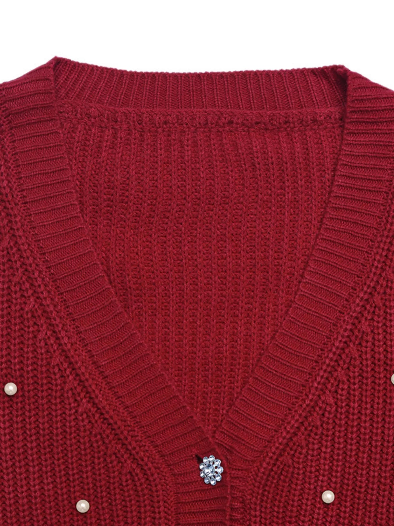 Red acrylic knit cardigan with pearl and rhinestone button details.