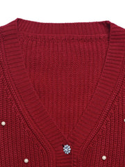Red acrylic knit cardigan with pearl and rhinestone button details.