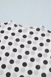 Chic polka dot mesh mock neck shirt in white with black and grey dots, sheer polyester fabric.