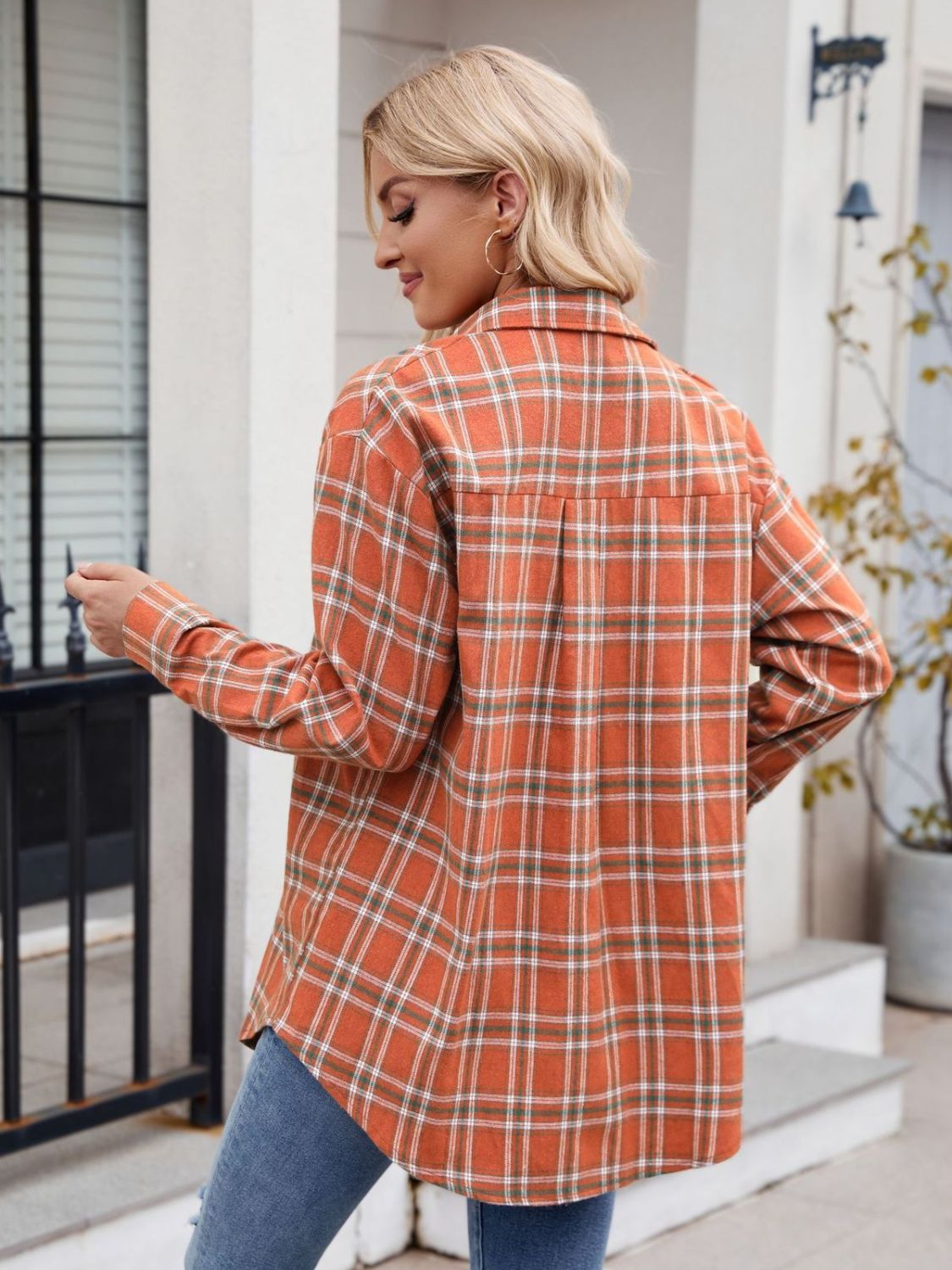 Orange plaid overshirt with buttoned front and patch pockets, long sleeves.